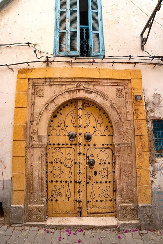 Detailed yellow ornate design of a typical door in the Medina of Tunis, a UNESCO designated quarter of the Tunisian capital, Tunisia