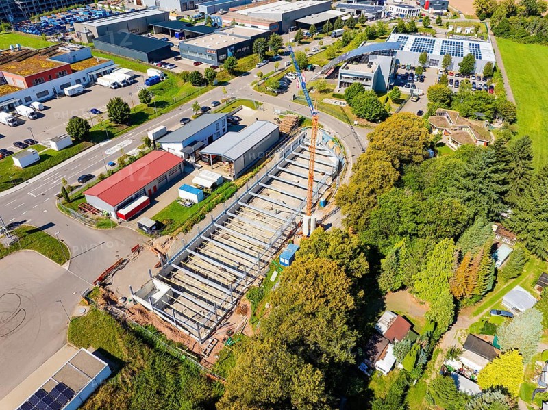 Aerial view of a large construction site with extensive vegetation and several buildings, Parkhaus Bau, Calw, Germany