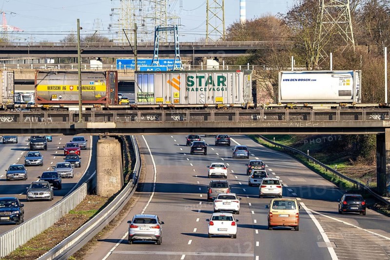 Freight train crosses the A42 motorway at Oberhausen-Zentrum on a railway bridge, the railway line comes from or goes to the OB-Osterfeld marshalling yard, busy cargo train line, North Rhine-Westphalia, Germany