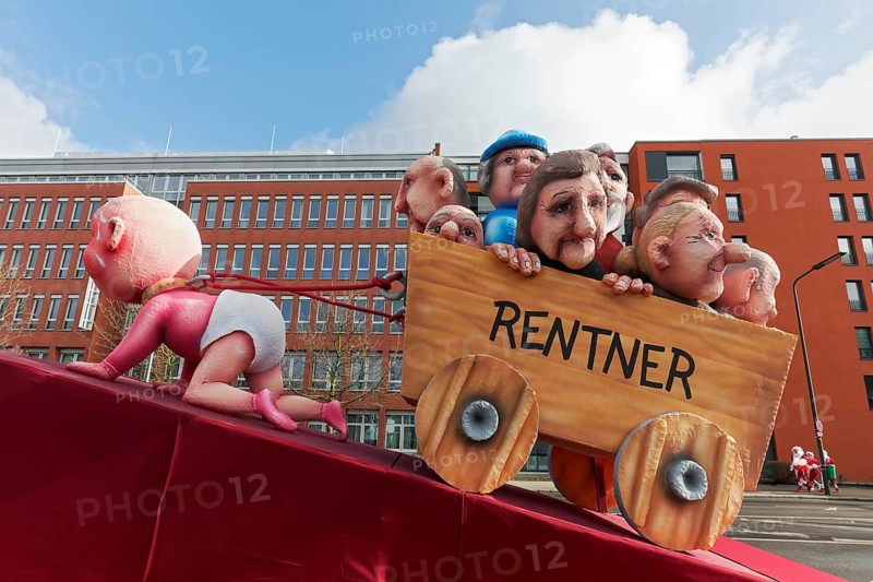 Crawling baby pulls carts full of pensioners, pension discussion, theme car by Jacques Tilly, Düsseldorf Rose Monday train, Düsseldorf, North Rhine-Westphalia, Germany