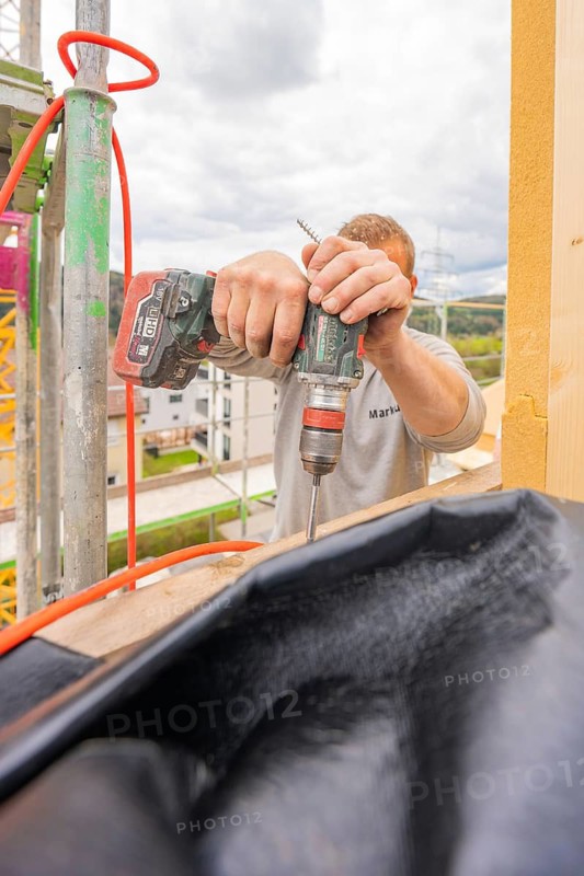 A craftsman drills wood on a construction site, residential renovation, Nagold, Calw district, Germany