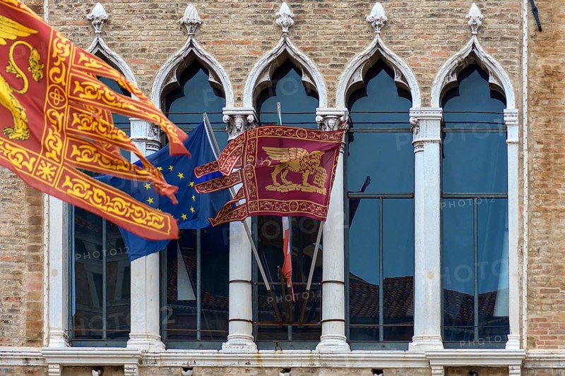 Waving flags of Europe and the Republic of Venice at Palazzo Zaguri, Venice, Venice, Italy