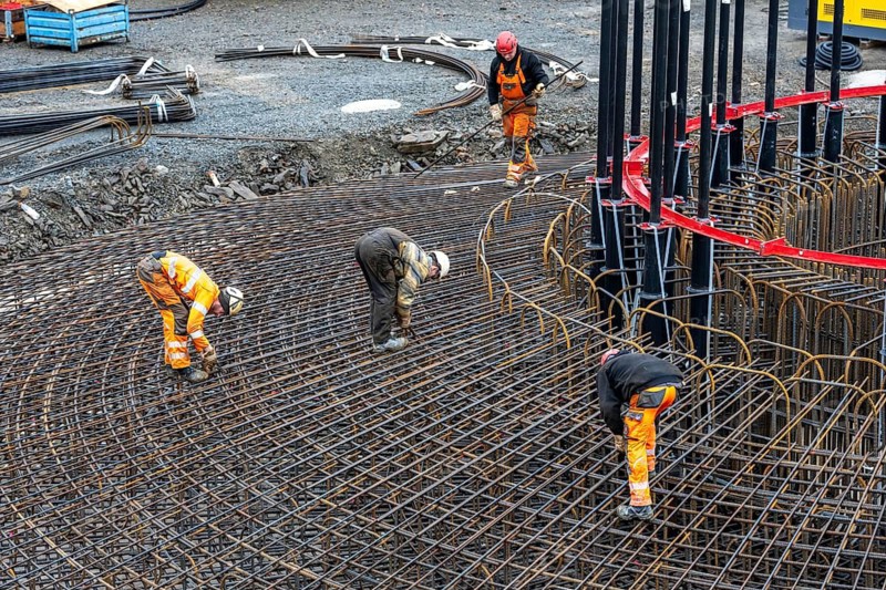 Assembly of reinforcing steel for the reinforced concrete foundation of a wind turbine, a mesh of rebar and reinforcing steel mesh, connecting the steel elements with binding wire, twisting with tongs, over 100 tons of reinforcing steel were used, the wind turbine will have a hub height of 160 meters, part of a new wind farm in Sauerland, near Balve, North Rhine-Westphalia, Germany