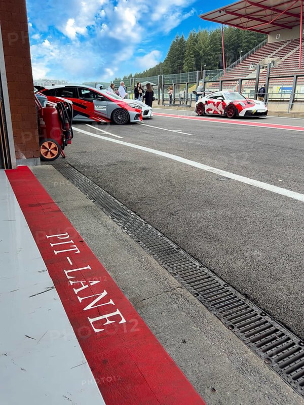 View from box for racing cars on pit lane with Porsche 911 sports car version for motorsport during track day, red line below with Marlkerung Pit-Lane lettering, Circuit de Spa Francorchamps, Stavelot, Ardennes, Walloon Region Wallonia Wallonia, Belgium