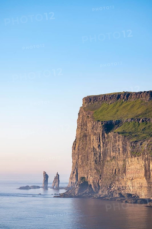 The Risin og Kellingin pinnacles off the Eysturoy cliffs in the evening light, Faroe Islands, Denmark