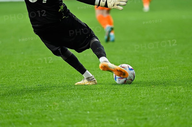 Football goalkeeper kicks ball. Player's legs and the ball during soccer match in Lubin, Poland