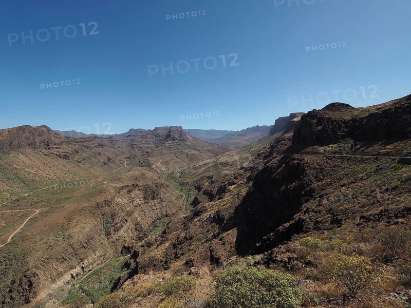 Rocky mountain landscape under clear sky with deep gorge, Barranco de Fataga, Gran Canaria, Spain