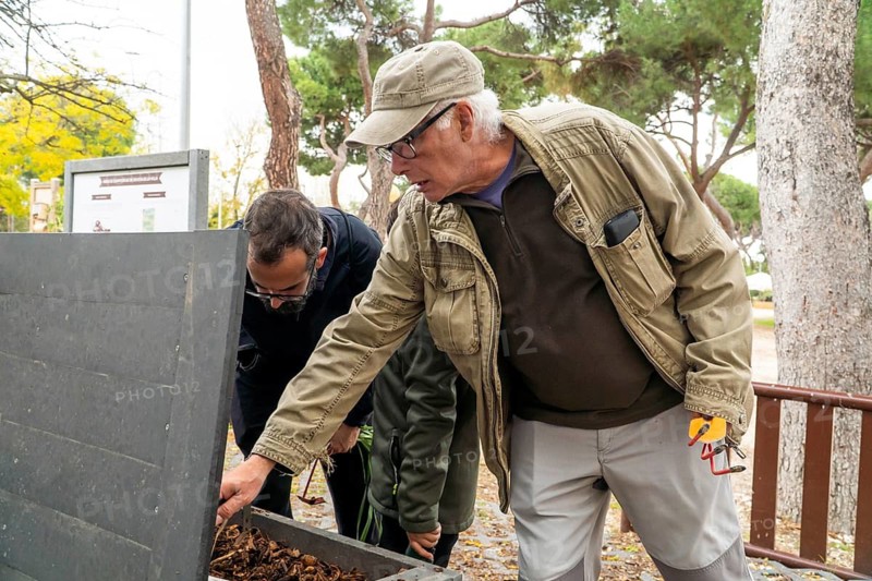 A multigenerational family collaborates in an urban garden, nurturing plants and composting. The scene showcases bonding, sustainability, and communal effort in a city setting