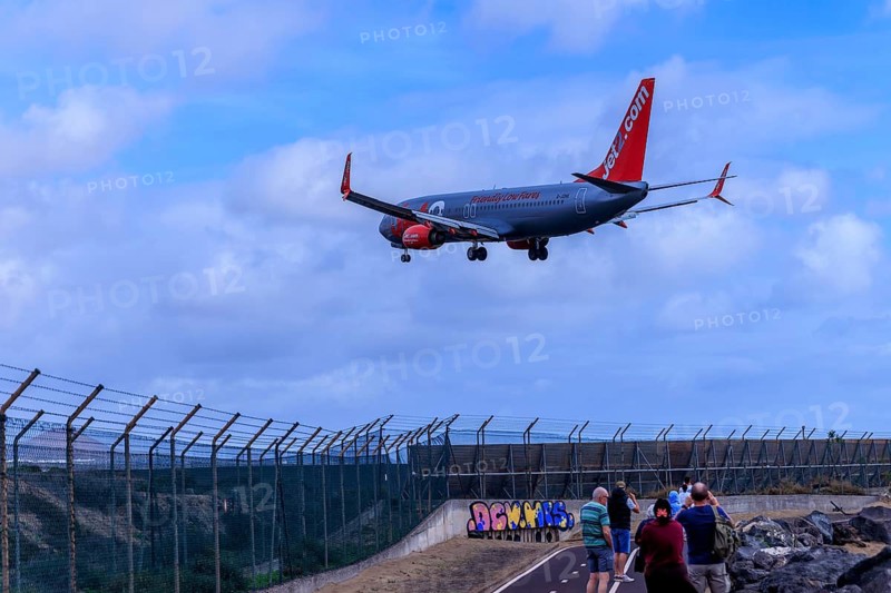Lanzarote, Canary Islands, Spain, Europe, airport near Arrecife, plane landing over a fenced area, watched by people