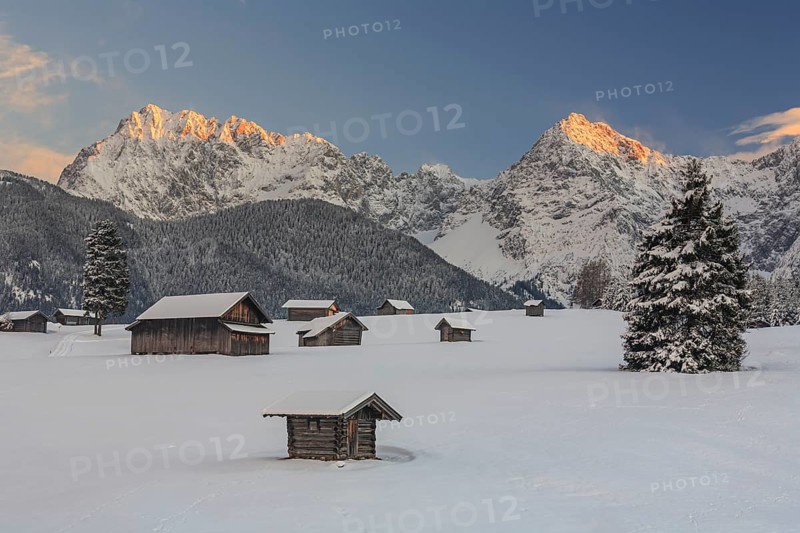 Huts in snowy mountain landscape, evening light, Werdenfelser Land, view of Karwendel Mountains, Upper Bavaria, Bavaria, Germany