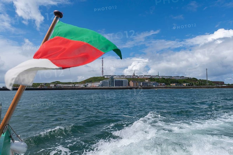 View from south-east to harbour facilities, Unterland and Oberland, offshore island Heligoland, Heligoland flag, radio tower, blue sky, North Sea, Pinneberg district, Schleswig-Holstein, Germany
