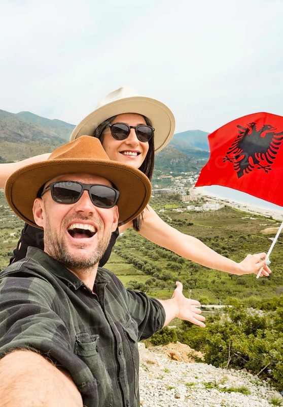 Happy young pretty woman handsome woman tourist enjoying summer holiday in Sarande, Albania - Traveling life style concept taking selfie in Balkans - Tourism and summertime vacation concept