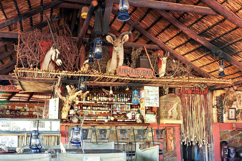Rustic bar with wooden decor, animal skulls and a cozy atmosphere, the bar of a small lodge in Namibia