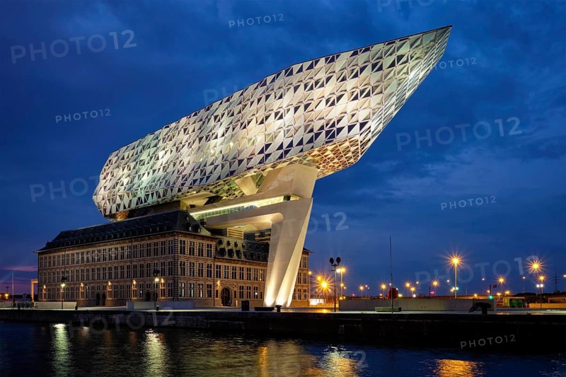 ANTWERP, BELGIUM, MAY 27, 2018: Port authority house (Porthuis) designed by famous Zaha Hadid Architects which was her last project illuminated in the night