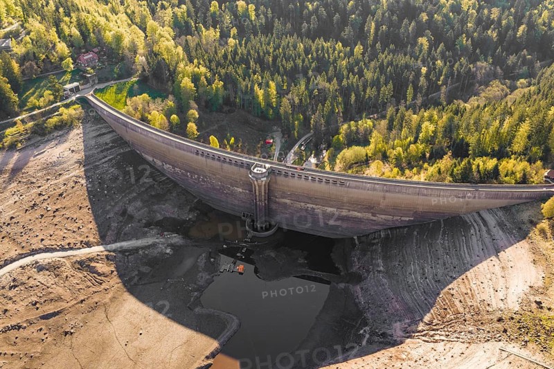 Dam in autumn landscape with bare riverbed and surrounding forest, emptied Schwarzenbach dam, Forbach, Black Forest, Germany