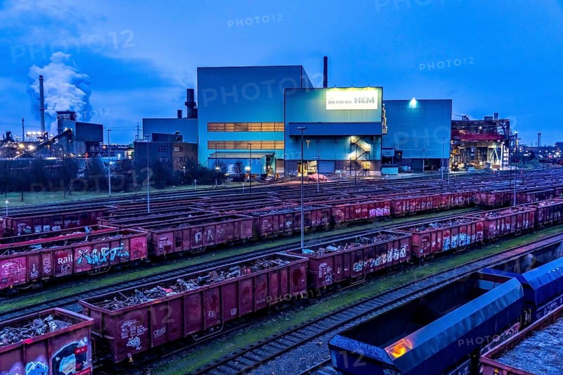 Hüttenwerke Krupp-Mannesmann, HKM in Duisburg, houses of the blast steel plant, coking plant, extinguishing tower with fire cloud, marshalling yard tracks, freight wagon with scrap metal, for melting down, North Rhine-Westphalia, Germany