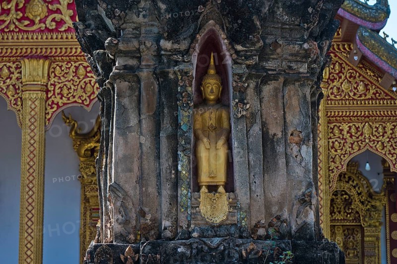 Small golden Buddha in front of Wat Xieng Mouane, Luang Prabang, Laos