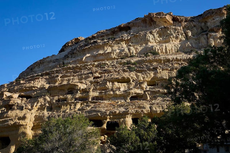 Neolithic caves, former hippie paradise, sandstone cliffs with natural caves and footbridges under blue skies, Matala, south coast, Crete, Greek islands, Greece