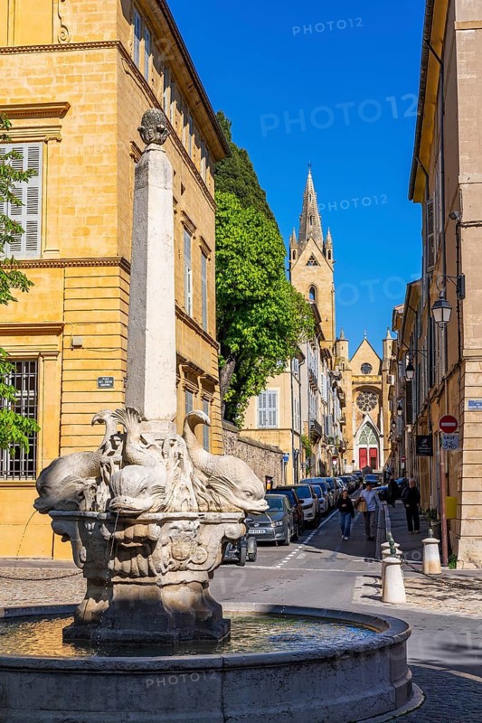 Fountain with four dolphins at Place des Quatre Duphins, in the back the church of St. John of Malta, Saint-Jean-de-Malte, Quartier Mazarin, old town of Aix-en-Provence, Bouches-du-Rhone, Provence, France