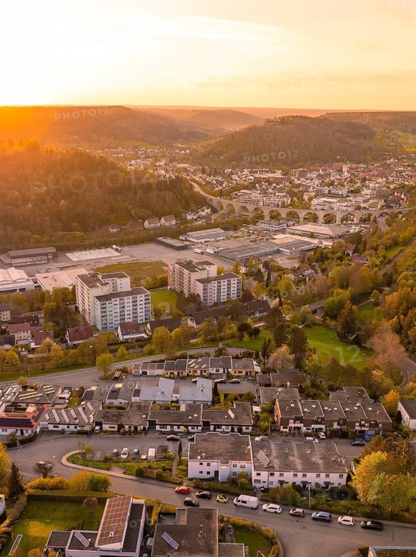 Cityscape at sunset with residential buildings and hilly surroundings, Nagold, district of Calw, Germany
