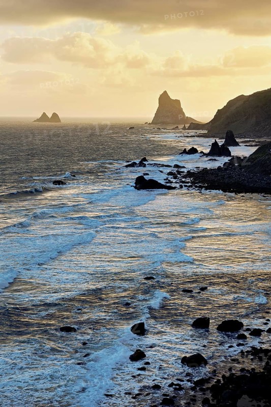 Beach of Playa de Benijo at high tide with the rock Roques de Anaga in the light of the rising sun, Tenerife, Canary Island, Spain