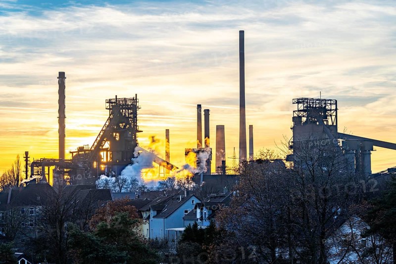 Blast furnace Schwelgern 1 and 2, ThyssenKrupp Steel Schwelgern plant in Duisburg-Marxloh is part of the Bruckhausen steelworks, sunset, North Rhine-Westphalia, Germany