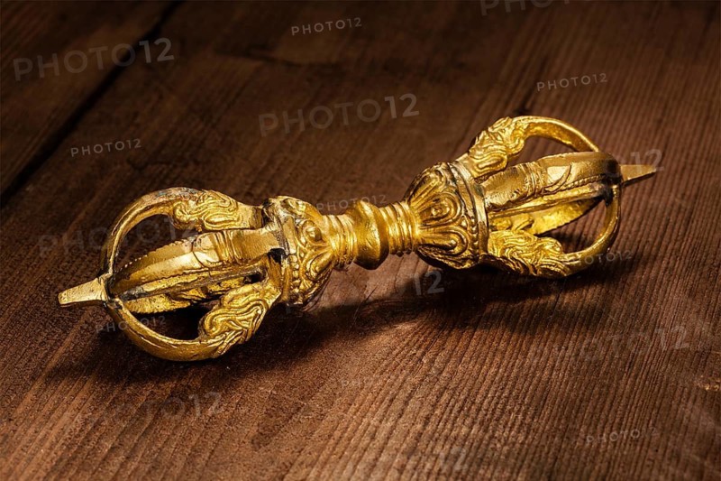 Tibetan Buddhist Dorje vajra ceremonial item on wooden background