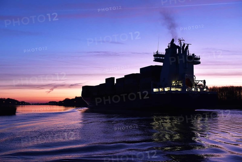 Container ship OOCL RAUMA at the blue hour, sunrise in the Kiel Canal, NOK, Kiel Canal, Schleswig-Holstein, Germany