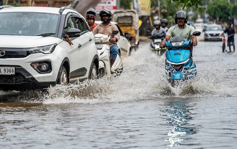 Commuters passing through a waterlogged street following heavy rainfall in Guwahati, India, on 1 June 2025