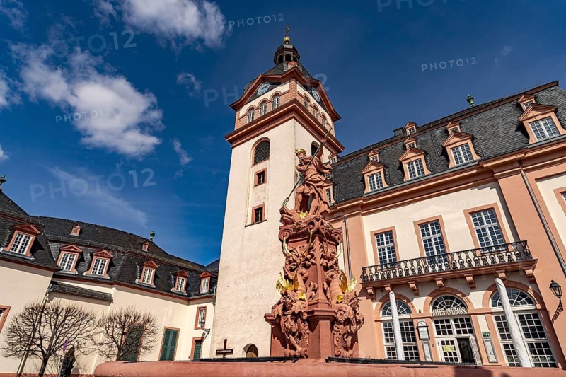 Market fountain with Neptune in front of the Old Town Hall and the castle church of Weilburg Castle, Hesse, Germany