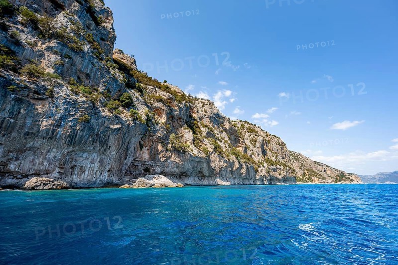 Picturesque rocky coast, cliffs and blue sea, Golfo di Orosei, Baunei, Sardinia, Italy