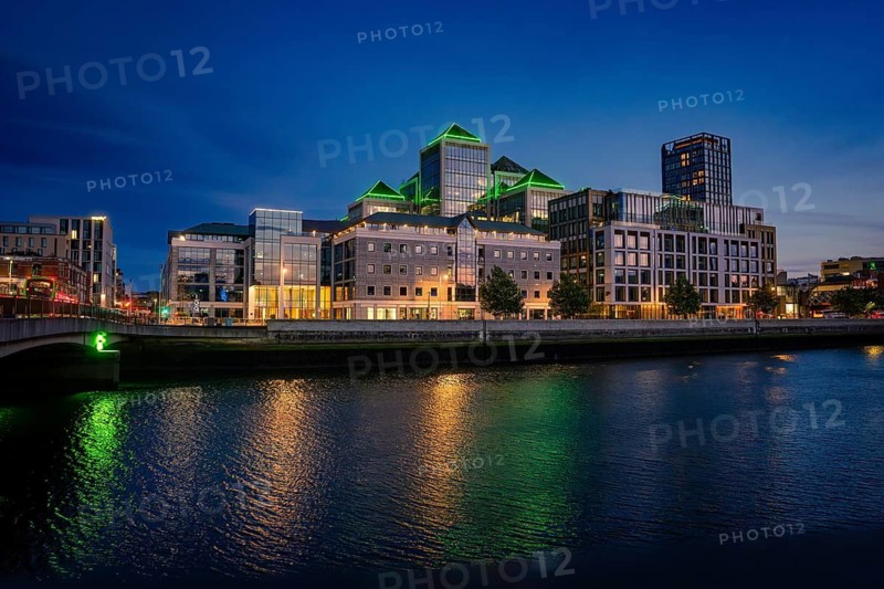 Modern urban skyline at night, reflecting lights on the river, Dublin, Ireland