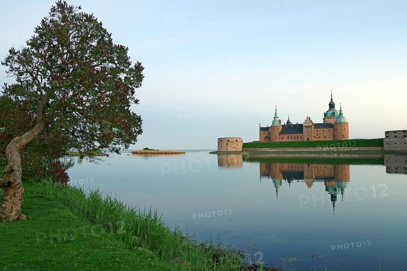 Historic castle reflected in peaceful lake, surrounded by trees, Kalmar Slott, Kalmar, Kalmar Län, Sweden