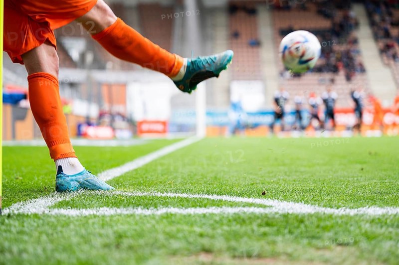 Footballer takes the corner. Detail of player's legs and the ball during soccer match in Lubin, Poland