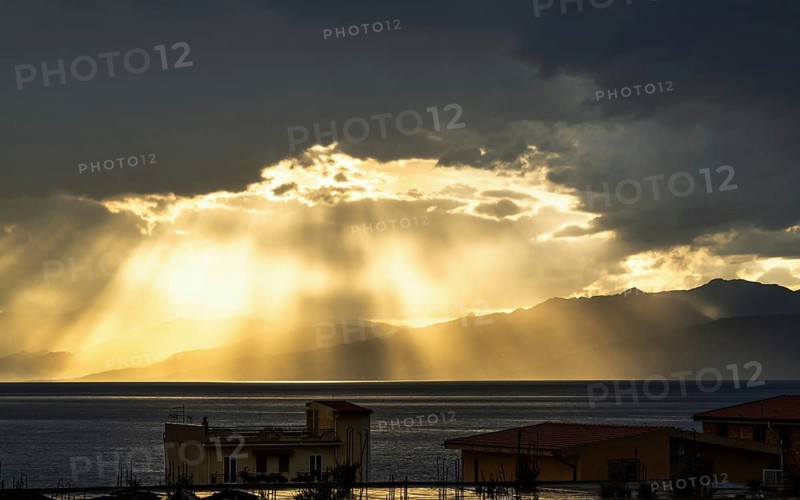 Sun rays in the clouds over Sicily, Tyrrhenian Sea, Italy