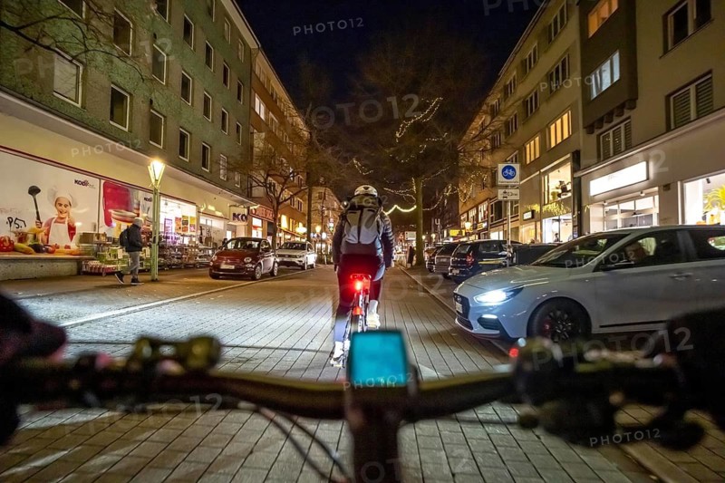 Cycling in the city, in the dark, in the evening, inner-city road, bicycle road, two-wheeler traffic has priority, 30 km/h zone, cyclist perspective, Essen, North Rhine-Westphalia, Germany