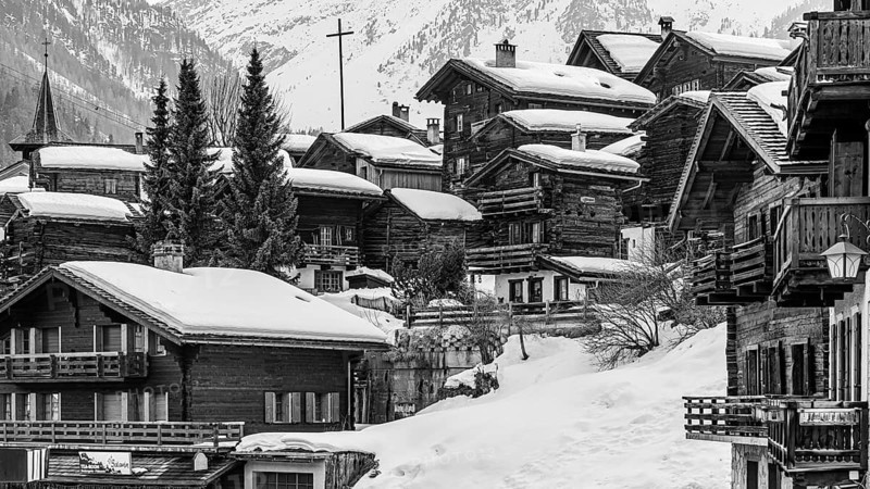 Snow-covered old farmhouses, large wooden cross, black and white photo, historic town center, Grimentz, Val d'Anniviers, Valais Alps, Canton of Valais, Switzerland