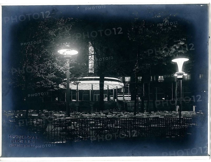 Berlin, Charlottenburg, zoological garden, zoo restaurant at night, modern lighting, nocturnal scene with illuminated outdoor area of a restaurant and empty tables and chairs, 1930