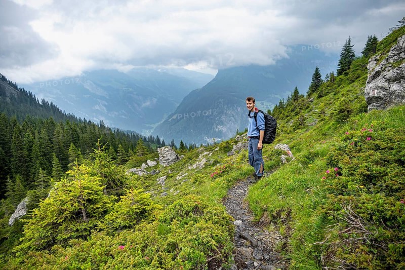 Mountaineers on a hiking trail, cloudy mountains, Bernese Alps, Bernese Oberland, Switzerland