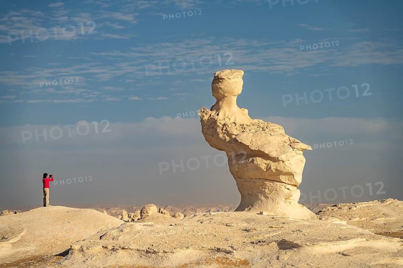 Touris photographs the white limestone formations in the White Desert National Park in the Egyptian part of the Libyan Desert, Egypt