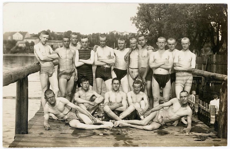 German Eylau, Ilawa, Poland, men, jetty, lake, outdoor pool, group of men in bathing suits gathered on a wooden walkway at the lake, photo Rogorsch, 1917