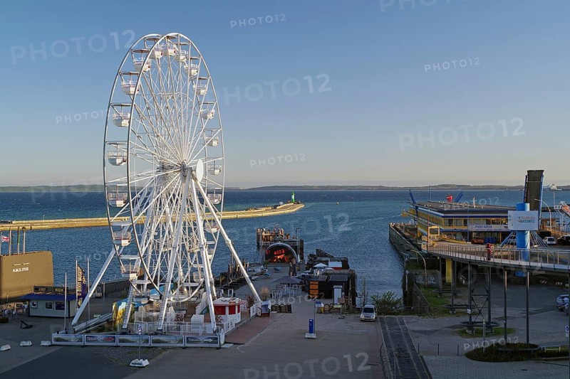 Ferris wheel in harbor with sea view and parked ships, Sassnitz, Rügen, Mecklenburg-Western Pomerania, Germany