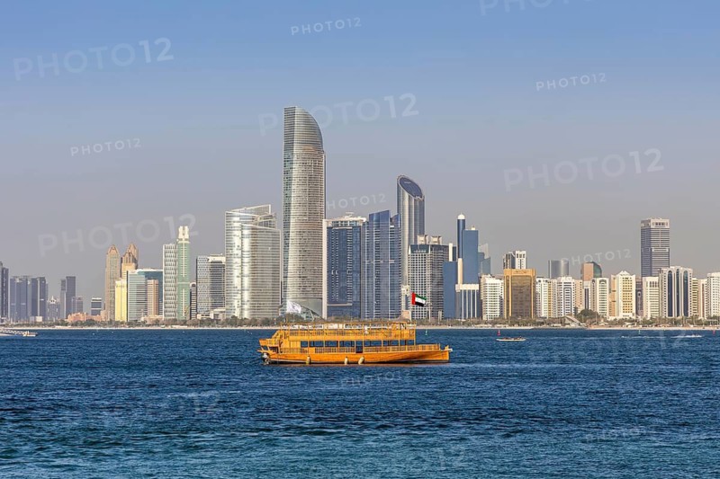 Abu Dhabi skyline skyscrapers by the sea with dhow in Abu Dhabi, United Arab Emirates