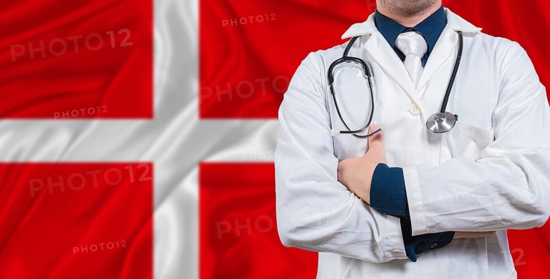 Male doctor with stethoscope on Danish flag. Doctor holding stethoscope on Danish flag