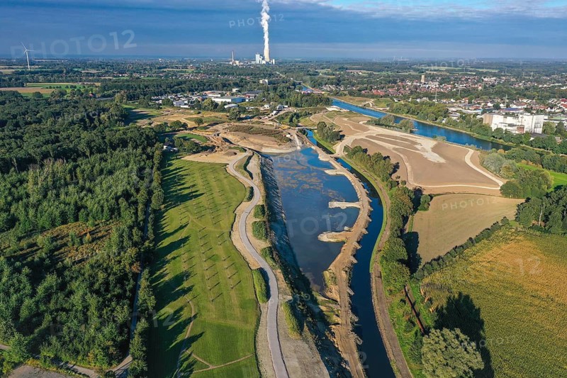 Recklinghausen, Castrop-Rauxel, North Rhine-Westphalia, Germany - EMSCHERLAND construction project, a 37-hectare water and nature discovery park at the water crossroads of the Rhine-Herne Canal and the renaturalised Emscher on the city boundary of Recklinghausen and Castrop-Rauxel. The ecological focal point at the confluence of Suderwicher Bach and Emscher will also be a future garden for the International Garden Exhibition 2027. Before the renaturalisation, the Emscher river system was an open, above-ground wastewater canal, combined sewer with surface water and wastewater. The Uniper power plant Datteln 4 in the background