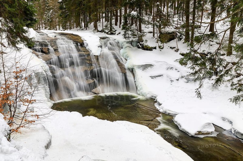 Mummel Falls in the snow, Mummel waterfall near Harrachsdorf in the Giant Mountains, Czech Republic