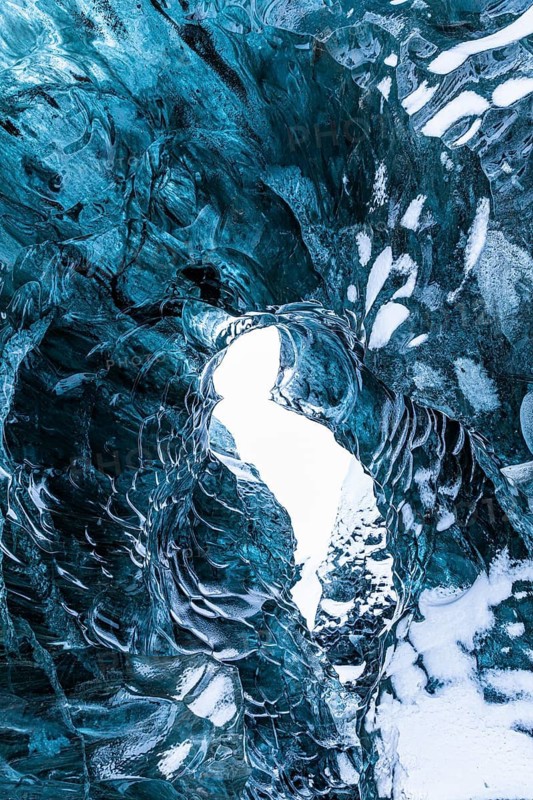 Ice cave open to the top with snow-covered ice combs, Pröng ice cave, Sudurland, Iceland