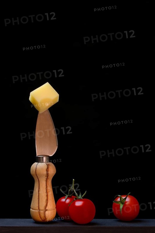 A piece of Swiss Emmental cheese on a cheese knife