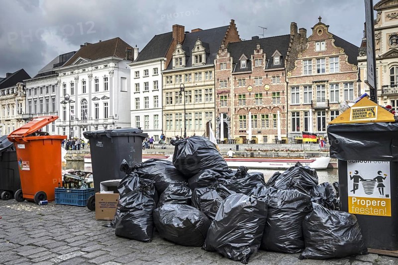 Rubbish bags and garbage containers with piled up household refuse due to strike by the waste processing firm IVAGO in the city Ghent, Belgium