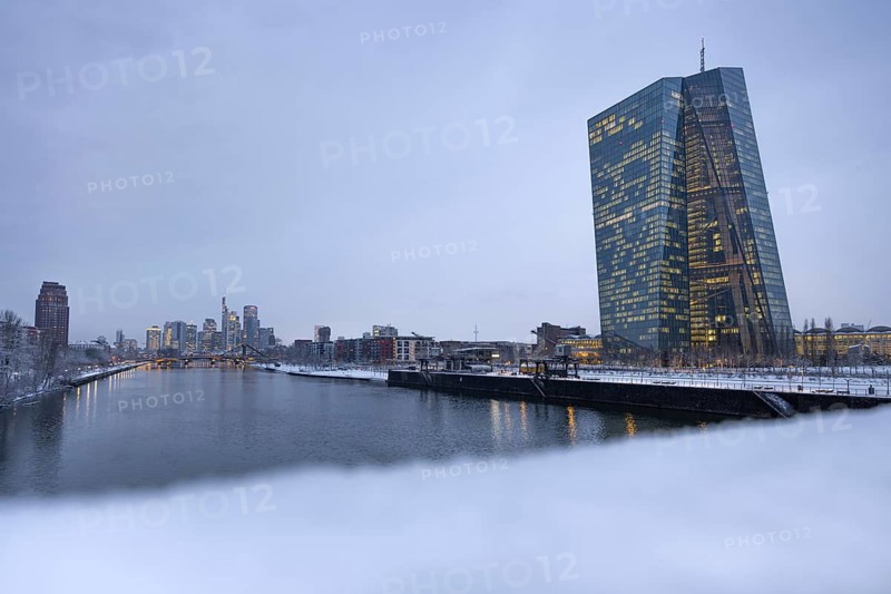 Snow lies along the banks of the Main from the European Central Bank (ECB) to the Frankfurt banking skyline, Osthafen, Frankfurt am Main, Hesse, Germany